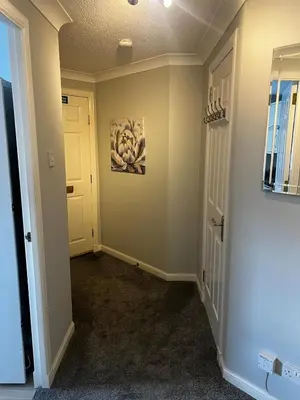 a hallway of a home with a door at 5 minutes to Glasgow airport in Paisley