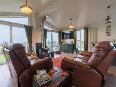 a living room with two leather chairs and a table at Chalet Loch Leven Lodge 25 East by Interhome in Kinross