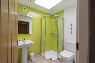 a bathroom with a shower and a toilet and a sink at Lord Galloway 33 with Hot Tub in Newton Stewart