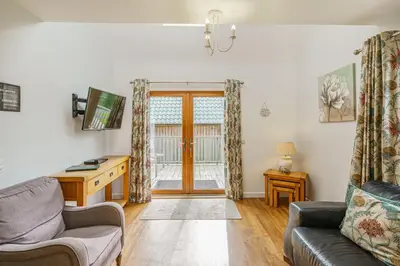 a living room with a couch and a desk at Lord Galloway 33 with Hot Tub in Newton Stewart