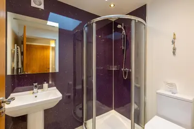 a bathroom with a shower and a sink at Lord Galloway 34 with Hot Tub in Newton Stewart