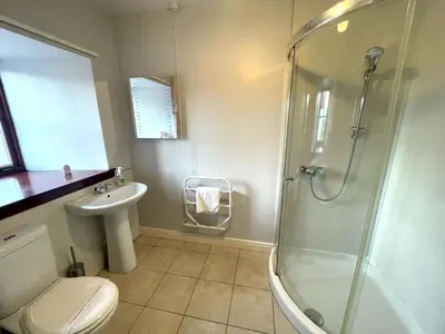 a bathroom with a shower and a toilet and a sink at Beautiful Rural 3BR Cottage with Stunning Views - Pass the Keys in Auldgirth