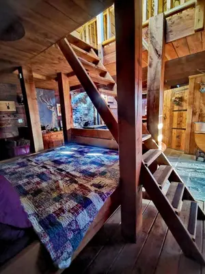 a bedroom with a bed in a wooden cabin at Ranch House in Newton Stewart