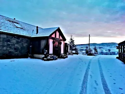 a house in the snow with footprints in the driveway at Ranch House in Newton Stewart