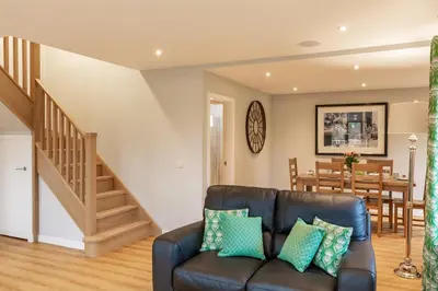 a living room with a couch and a dining room at Lord Galloway 39 with Hot Tub in Newton Stewart