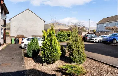 a row of trees in a parking lot at Ochil View Holiday Let in Tullibody