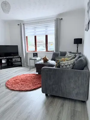 a living room with a couch and a red rug at Ochil View Holiday Let in Tullibody