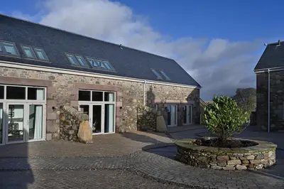 a stone building with a tree in front of it at Pigeon Cottage - Luxury country steading in Perth