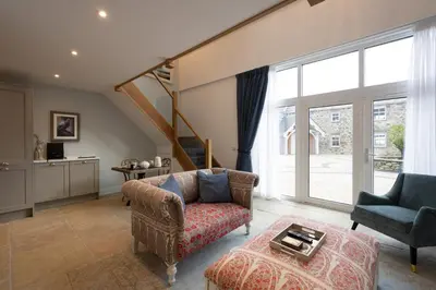 a living room with a couch and a chair at Pigeon Cottage - Luxury country steading in Perth