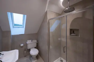 a bathroom with a shower and a toilet and a sink at Oystercatcher - Converted luxury steading in Perth