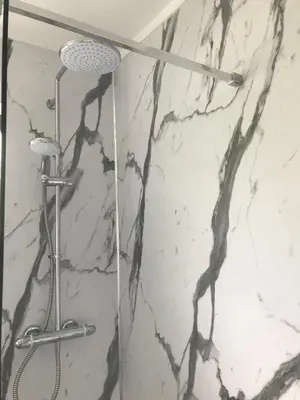 a shower with a black and white marble wall at Birch Lodge 17 with Hot Tub in Newton Stewart