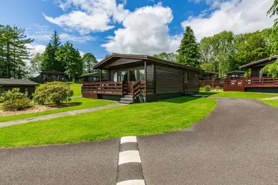 a house with a pathway leading to the front yard at Bluebell Lodge 9 with Hot Tub in Newton Stewart