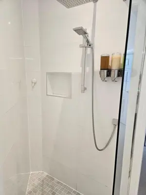 a bathroom with a shower with a glass door at Langhouse Castle Bed and Breakfast in Inverkip