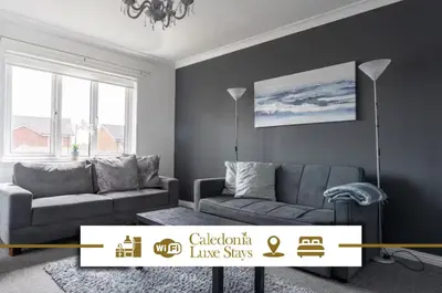 a living room with a couch and a table at Ferguson House in Airdrie