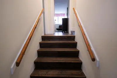 a stairway with wooden steps leading up to a room at Comrie Old Schoolhouse in Comrie
