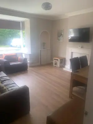 a living room with a couch and a table at Elegant bungalow in Newmilns, East Ayrshire in Newmilns
