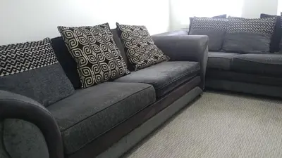 a gray couch with pillows on it in a living room at Dunoon Gourock Inverkip Apartment in Gourock