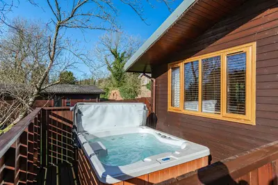 a hot tub on the side of a house at Laurel Lodge 6 with Hot Tub in Newton Stewart