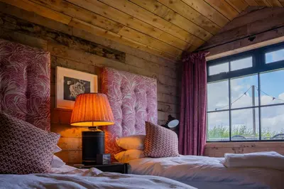 a bedroom with two beds and a window at The Artist's House at Jupiter Artland in Kirknewton