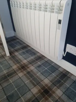a bed in a room with a checked floor at The Creek-Stone Den in Oban