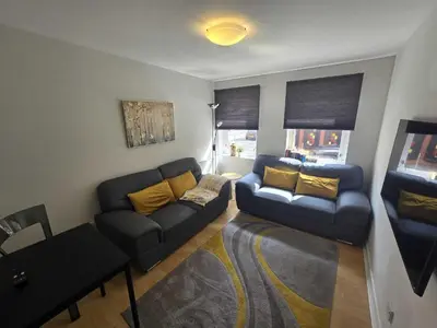 a living room with a couch and a table at Merchantcityflat in Glasgow