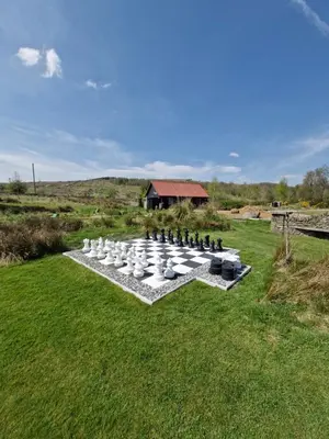 a group of white containers sitting on a grass field at The Bothy in Stirling
