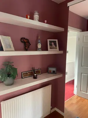 a room with purple walls and white shelves at Karibu Cottage near the airport in Edinburgh