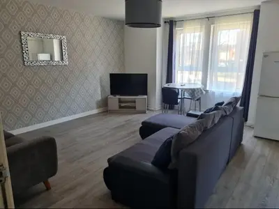 a living room with a couch and a tv at City, Celtic park & Emirates Stadium Apartment, for families or age over 23 in Glasgow