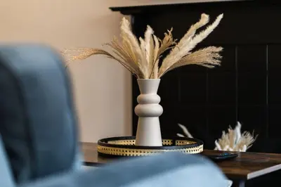 a vase with feathers in it on a table at Finnieston 1-Bed - Walk to Hydro & Bars - Sleeps 2 in Glasgow