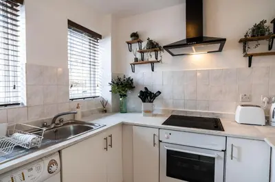 a kitchen with a sink and a stove top oven at Finnieston 1-Bed - Walk to Hydro & Bars - Sleeps 2 in Glasgow