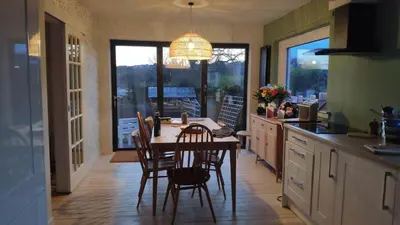 a kitchen with a table and chairs and a dining room at Chilowen - Happy House in Inverkeithing