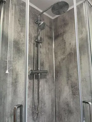 a shower with a shower head in a bathroom at Breadalbane Apartment in Oban