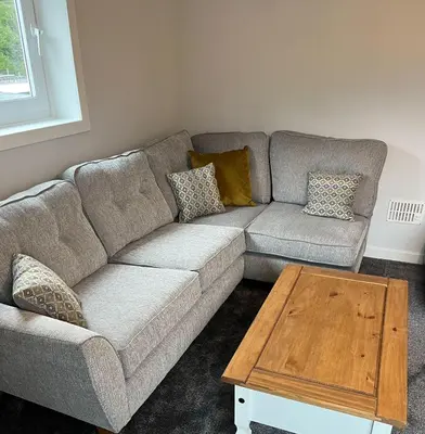 a living room with a couch and a coffee table at Breadalbane Apartment in Oban