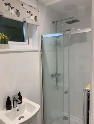 a bathroom with a shower and a sink at Lora Cabin in Oban