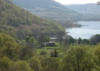 a view of a lake and a house in a valley at Blarcreen in Oban
