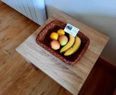 a basket of fruit sitting on a table at The Singing Heart, TirNaNog Cozy Cottage near Lochgilphead !!HIDDEN GEM!! in Lochgilphead