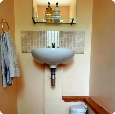 a bathroom with a white sink and a mirror at The Singing Heart, TirNaNog Cozy Cottage near Lochgilphead !!HIDDEN GEM!! in Lochgilphead