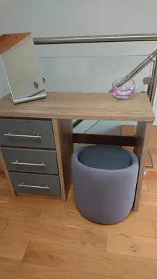 a desk with a laptop and a dog bowl under it at Sea Breezes in Oban