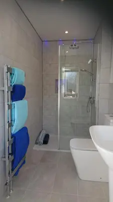 a bathroom with a shower and a toilet and a sink at Sea Breezes in Oban
