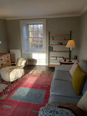 a living room with a couch and a window at Riverside House in Thornhill