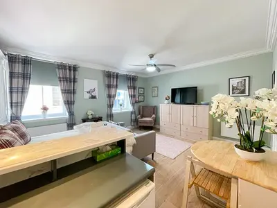 a living room with a couch and a table at Snug Studio on The Grassmarket, 5mins from Castle in Edinburgh