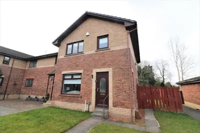 a red brick house with a black roof at Signature - Moore View in Hamilton