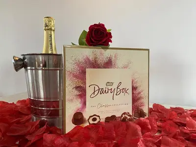 a picture of a bottle of champagne and red roses at Blair snug hut in Kelty