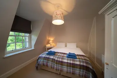 a bedroom with a bed with blue towels on it at Gatehouse, Bridge of Balgie, Glenlyon in Bridge of Balgie