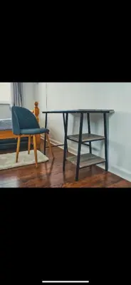 a blue chair and a table and a stool at Detached House with a private en suite room in Clydebank
