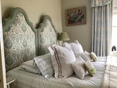 a bed with a bunch of pillows on it at Loch Gorm House in Bruichladdich