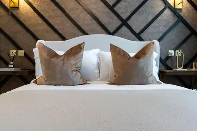 a white bed with two pillows on top of it at The Devonshire Suite - Your 5 STAR West End Stay! in Glasgow