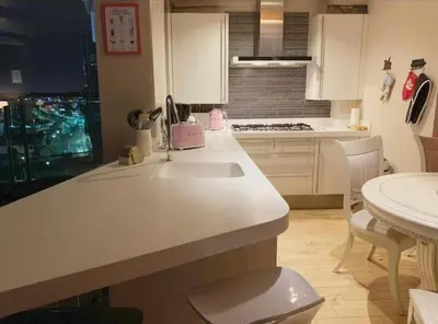 a kitchen with a white counter and a sink at Designer Penthouse with Riverviews - G1 Glasgow City Centre, 3 Bedrooms, 2 Bathrooms, 1 Living room / Kitchen. Full Floor, Wrap Around Terrace, Panoramic Views, Off Central Station / Buchanan Street in Glasgow