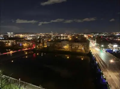 a view of a city at night with a river at Designer Penthouse with Riverviews - G1 Glasgow City Centre, 3 Bedrooms, 2 Bathrooms, 1 Living room / Kitchen. Full Floor, Wrap Around Terrace, Panoramic Views, Off Central Station / Buchanan Street in Glasgow