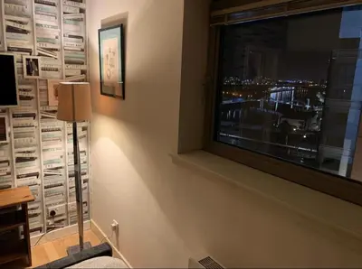a room with a window with a view of a city at Designer Penthouse with Riverviews - G1 Glasgow City Centre, 3 Bedrooms, 2 Bathrooms, 1 Living room / Kitchen. Full Floor, Wrap Around Terrace, Panoramic Views, Off Central Station / Buchanan Street in Glasgow
